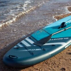 Gladiator Pro 10'8 X 34" Paddleboard 2023 -Surfing Equipment Shop gladiator 10 6 on beach front 1